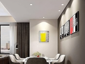 Modern dining area with six upholstered chairs around a rectangular table, wall art, LED Downlight Mercury Plus 18W ceiling lights, and a window overlooking the city.