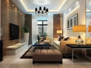 A modern living room featuring beige sofas, a brown ottoman, large windows, wall-mounted TV, chic decor, and warm lighting provided by the LED Downlight Mercury Plus 24W.